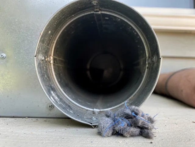 St. Simons Dryer Vent Cleaning technician using specialized equipment to clear severe dryer vent blockage in St. Simons